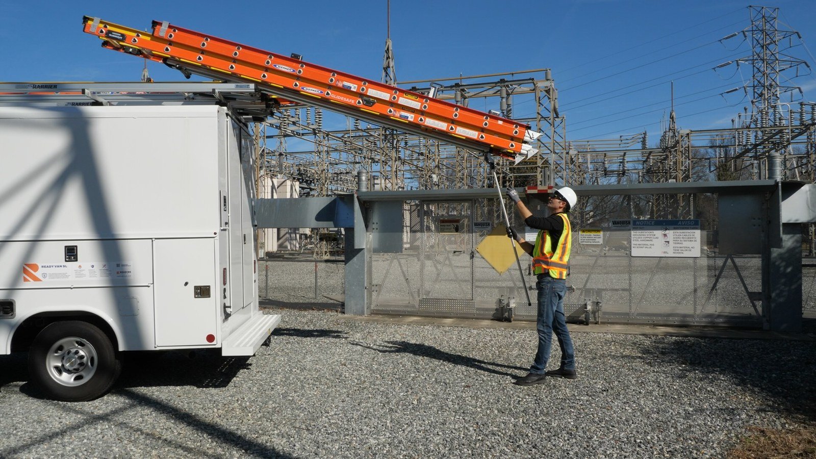 G2000 in action — utility worker extending ladder from Reading service body at an electrical substation